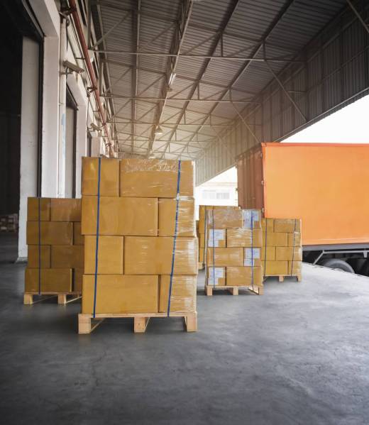 packaging-boxes-stacked-pallets-loading-with-shipping-cargo-container-freight-trucks-logistics